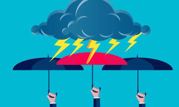 a group of umbrellas with a cloud and a person sitting under it