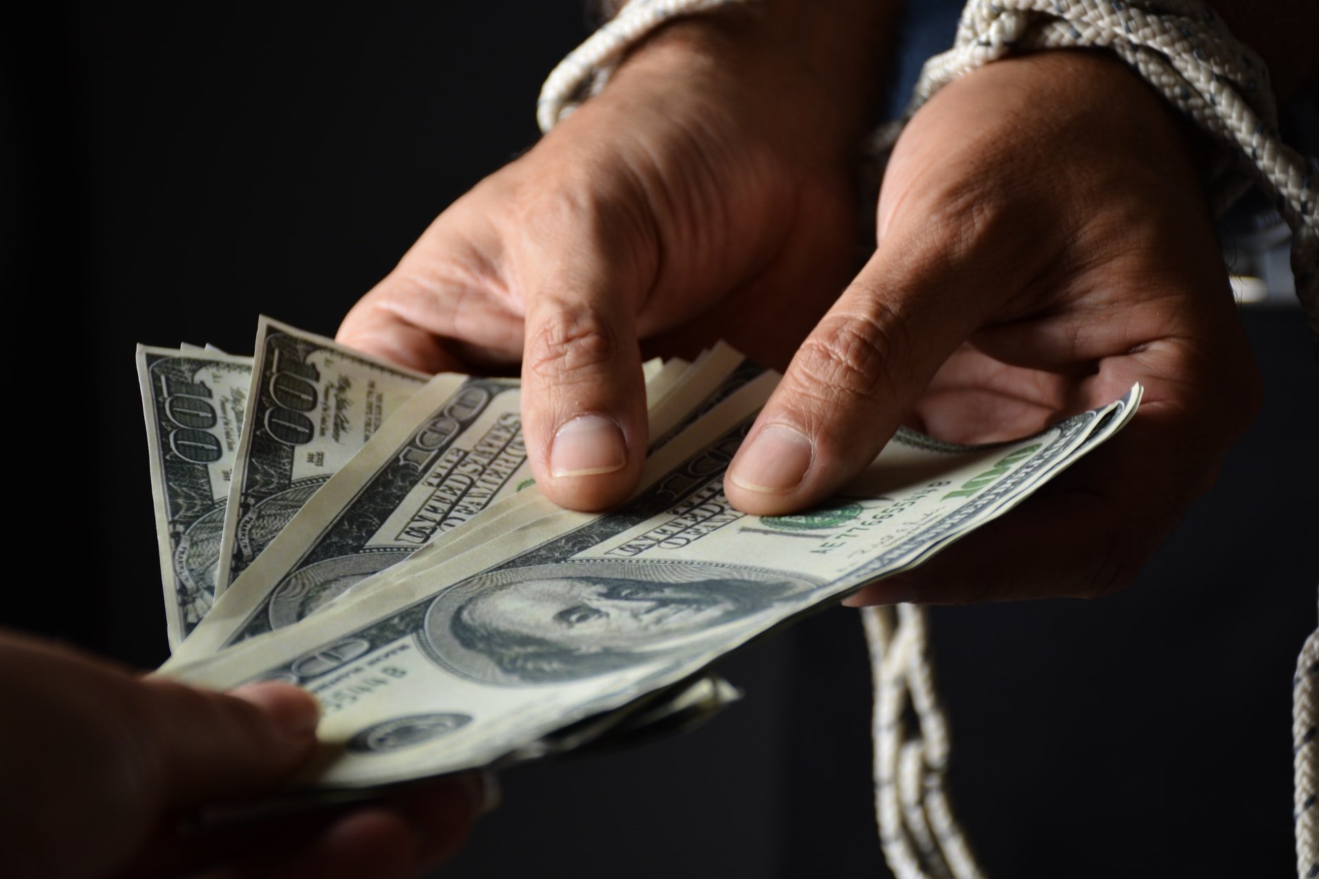 a person holding a fanned out money