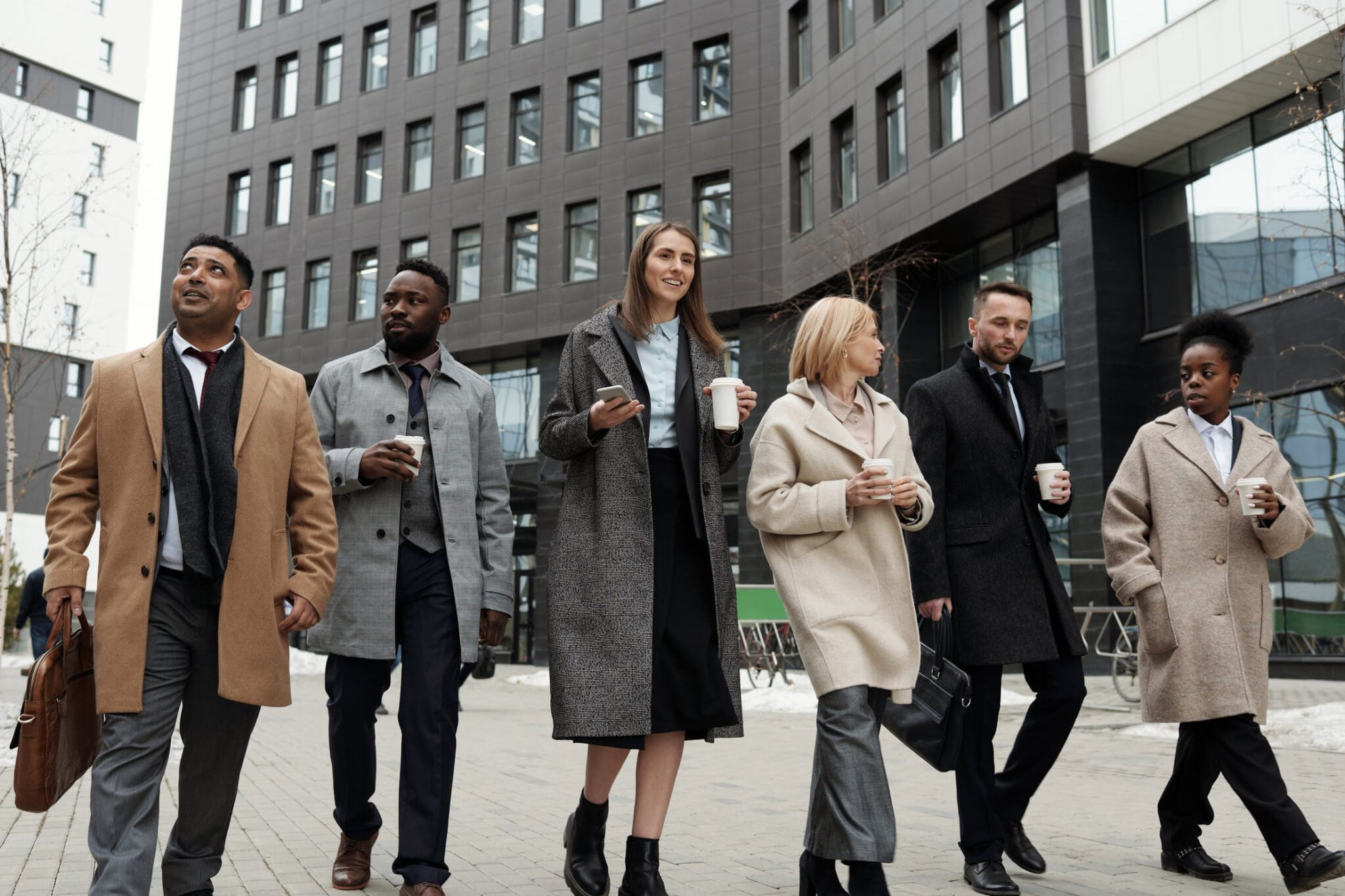 a group of people walking on a sidewalk