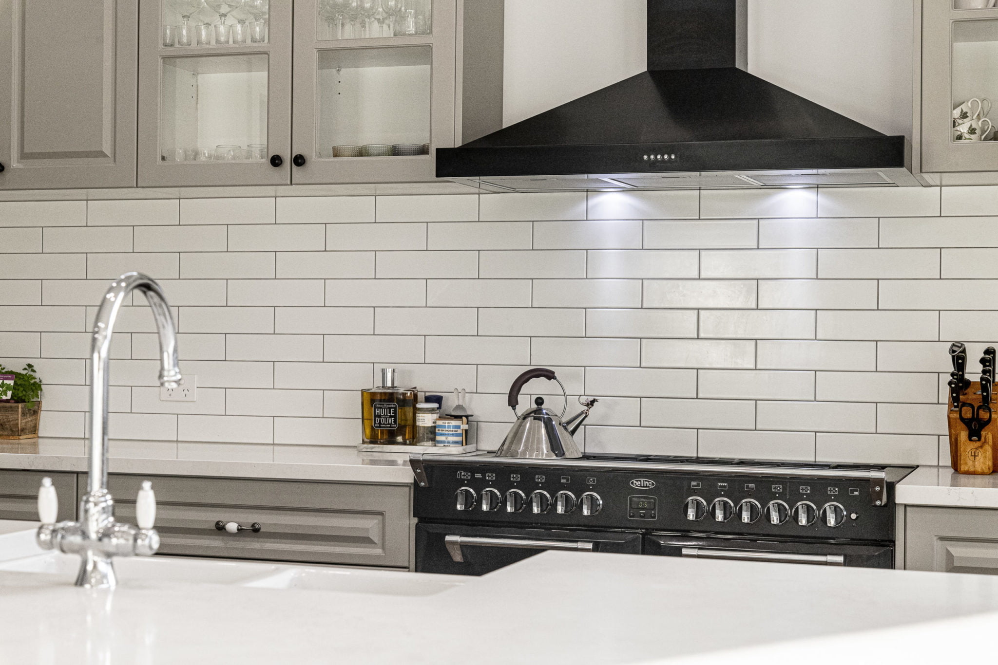 a kitchen with white tiles