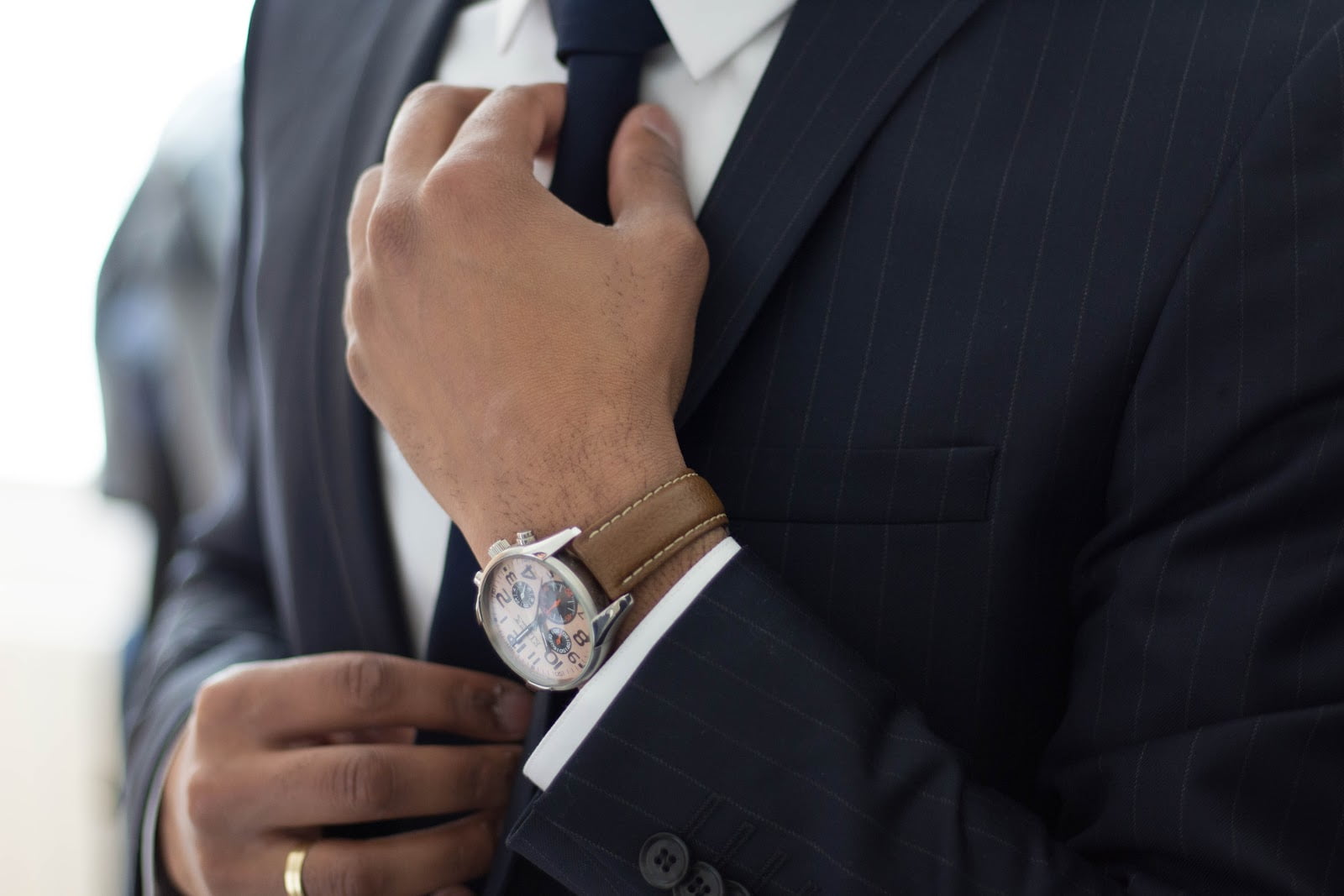 a man in a suit and a watch