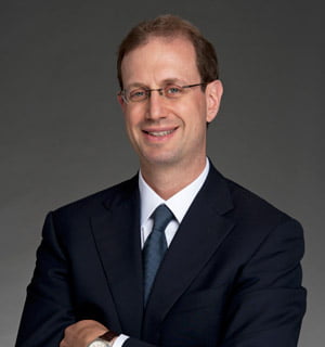 a man in a suit smiling