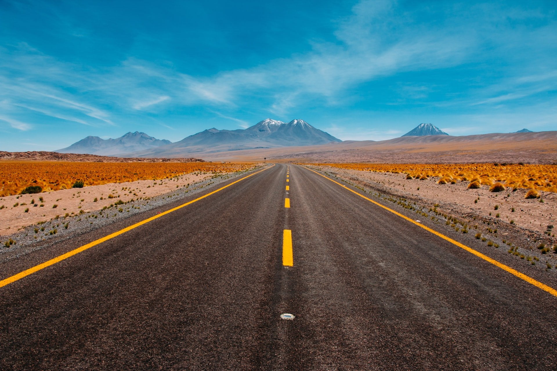 a road with mountains in the background