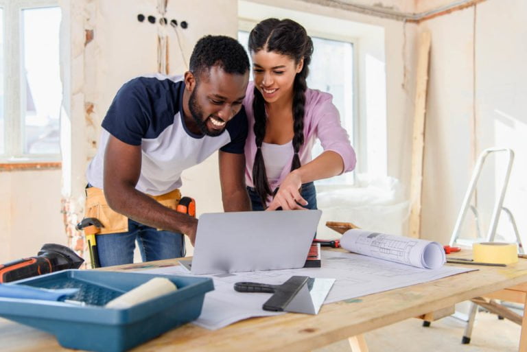 a man and a woman looking at a laptop