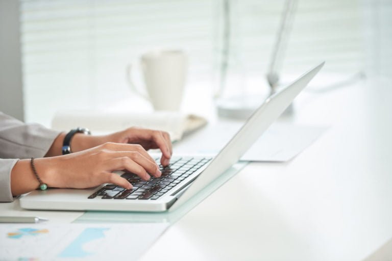 close-up of a person using a laptop