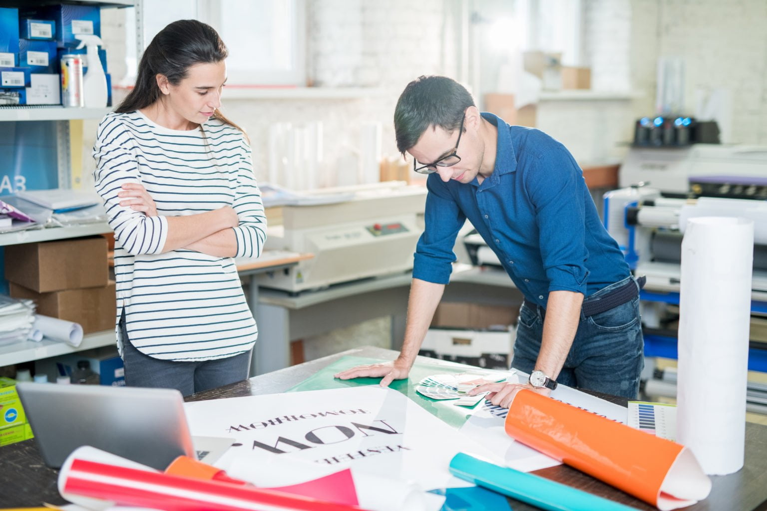 a man and a woman looking at a piece of paper