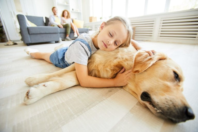 a boy lying on a dog