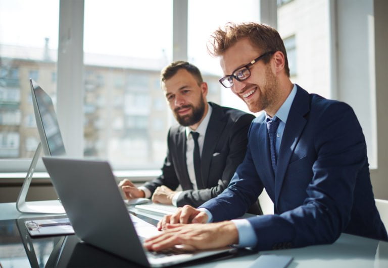men looking at a laptop