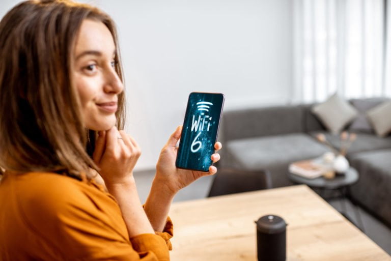 Woman using smart phone with 6 wi-fi network
